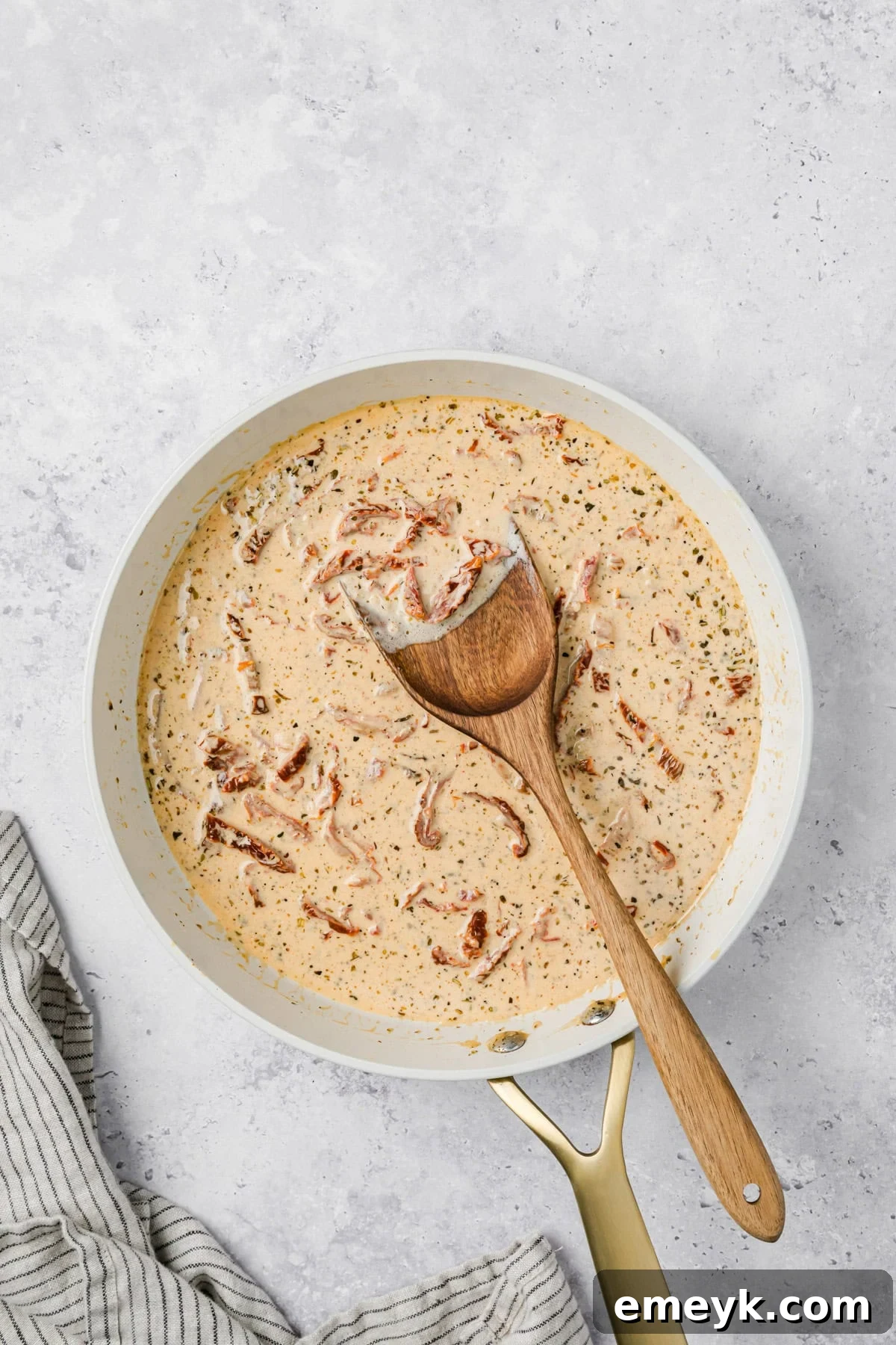 Marry Me Sauce in a skillet with a spoon 