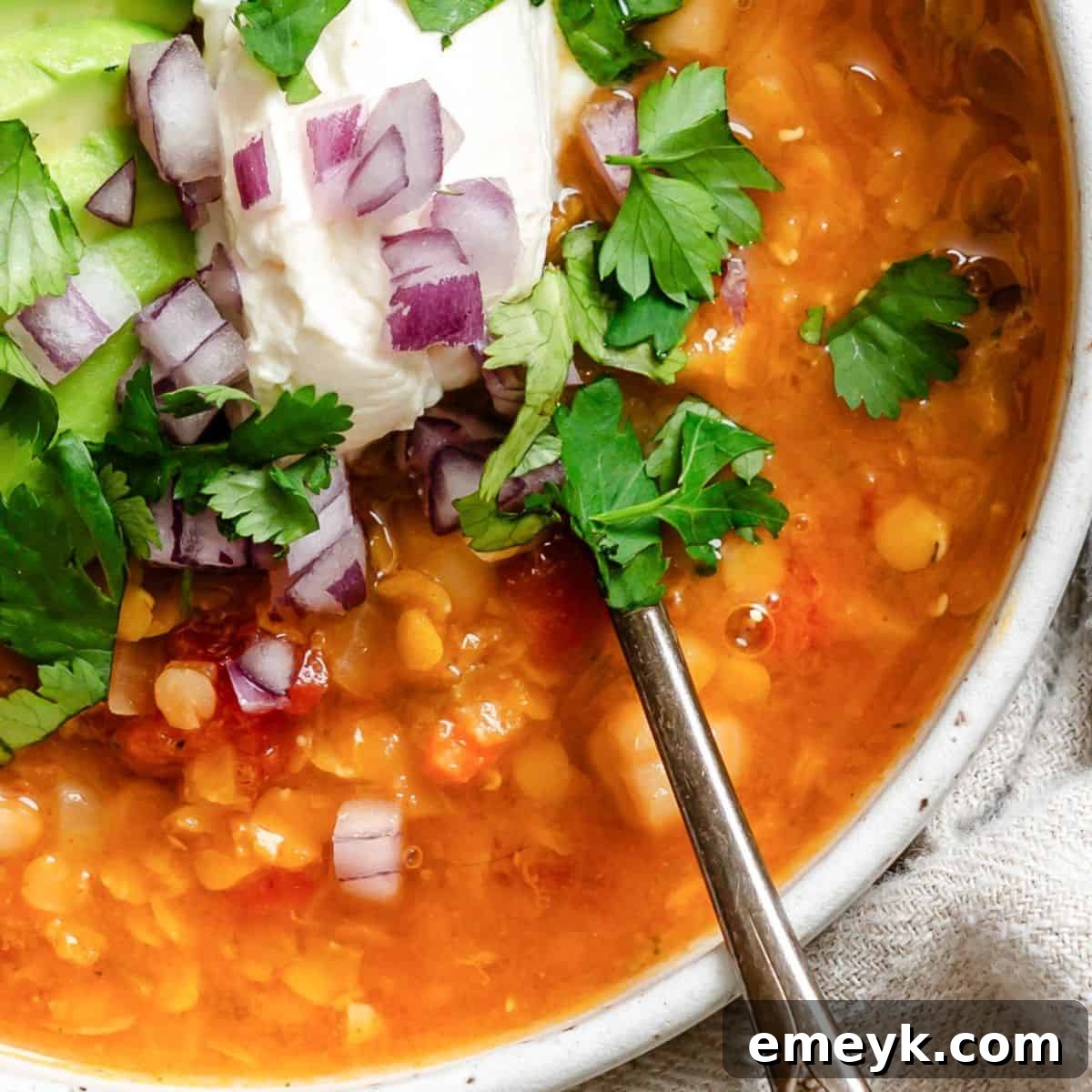 Hearty Lentil Bean Chili, topped with cheese.