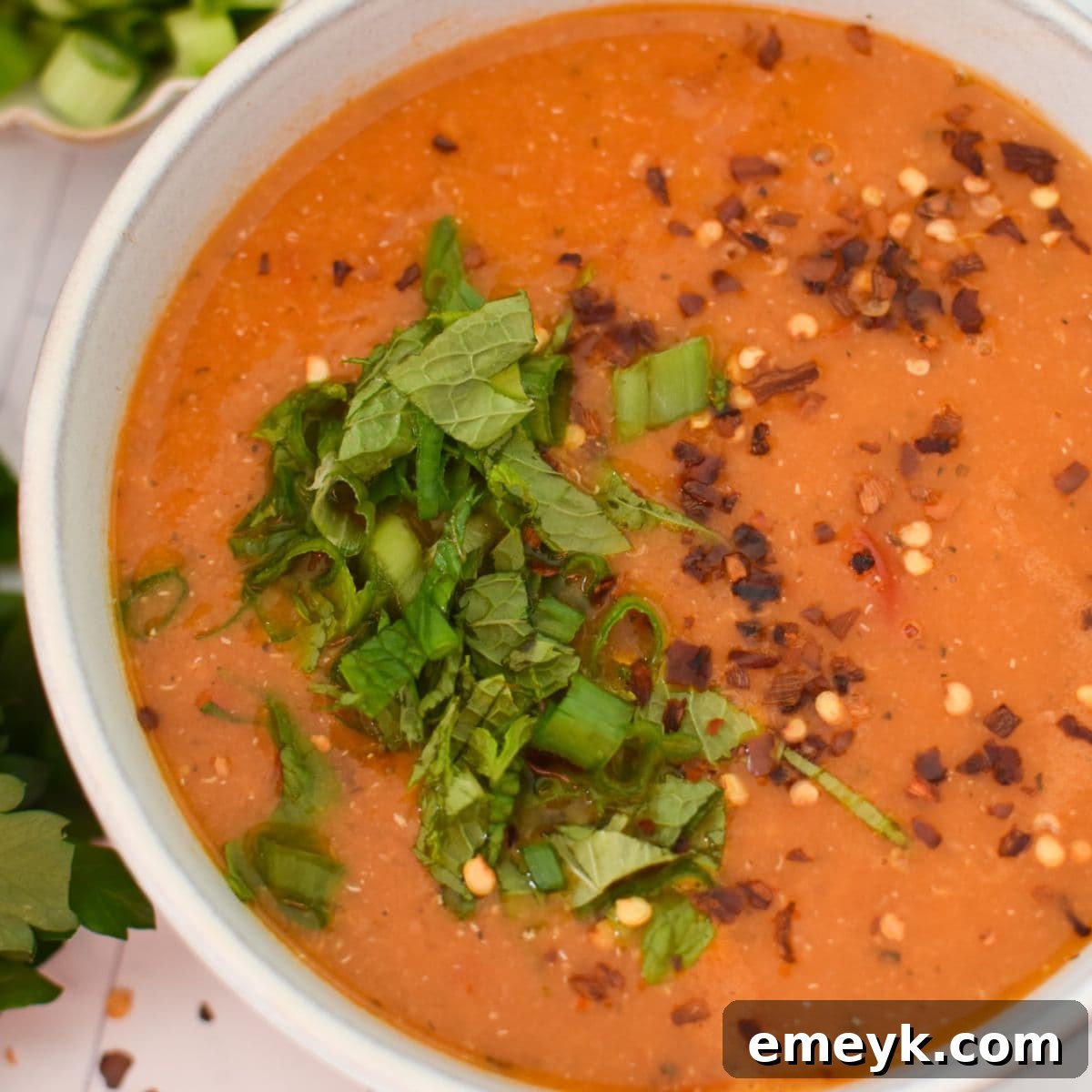 Delicious Turkish Lentil Soup, garnished with a swirl of chili oil.