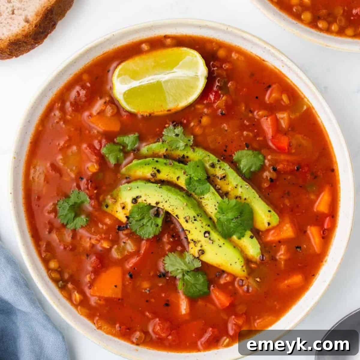 Colorful Mexican Lentil Soup with a lime wedge.