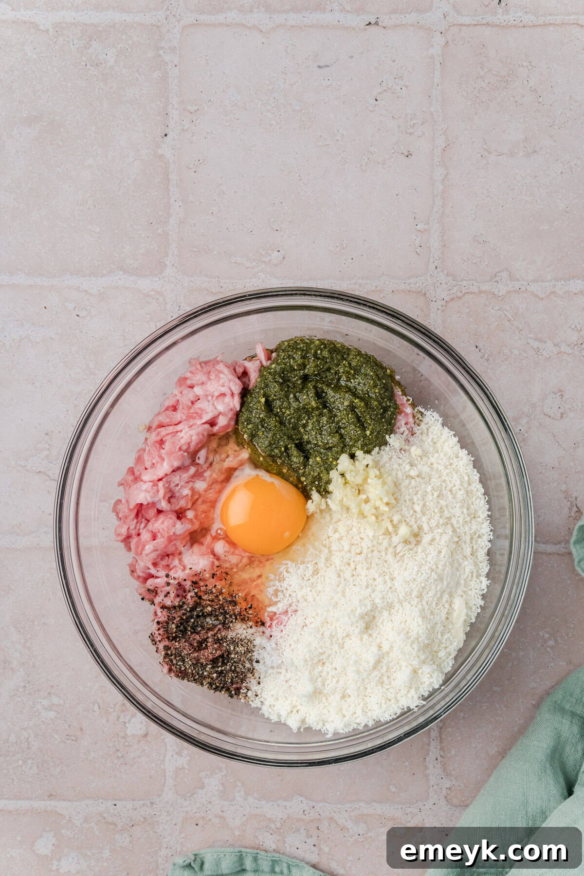 Turkey Pesto Meatball ingredients in a glass bowl, ready to be mixed.