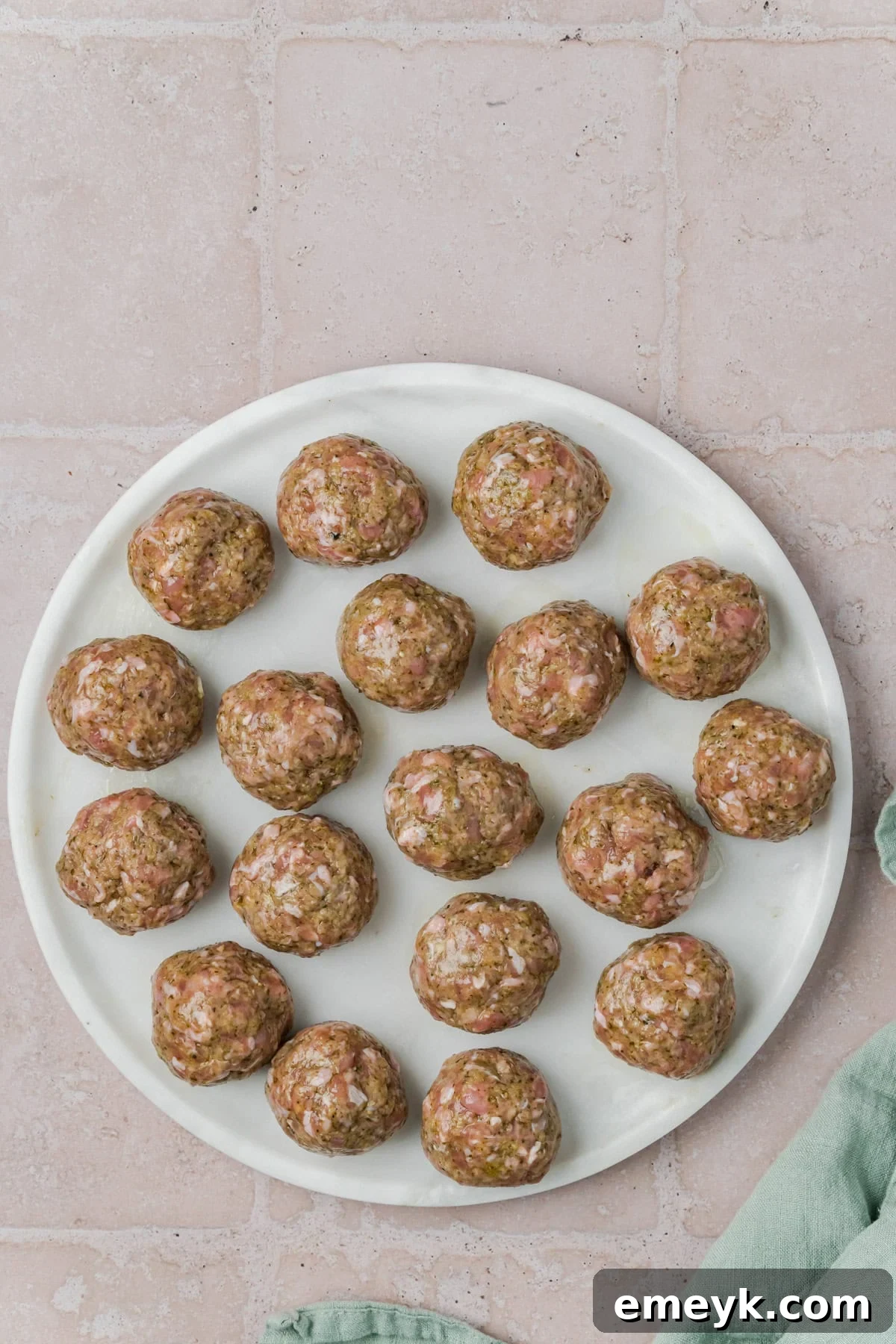Pesto Turkey Meatballs rolled on a plate.