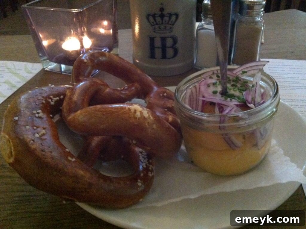Delicious pretzel with a side of traditional German cheese spread in Munich, Germany