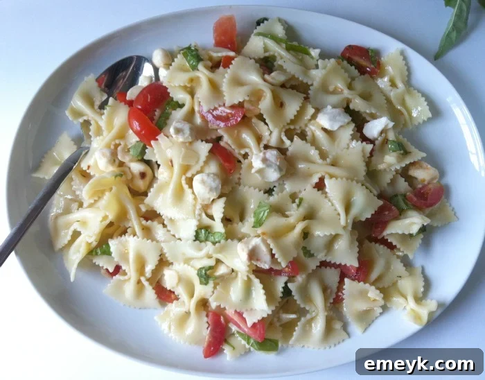 Vibrant Caprese Pasta 6 Close-up of a bowl of delicious Caprese Pasta Salad with perfectly cooked pasta, fresh mozzarella, and cherry tomatoes.