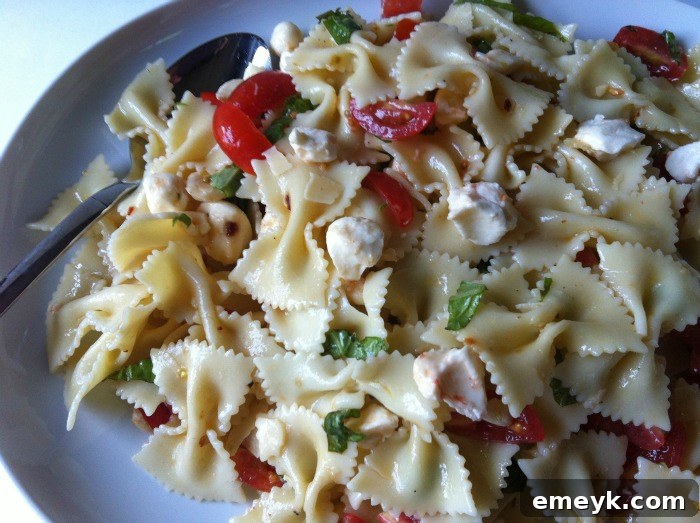 Vibrant Caprese Pasta 7 A large bowl of fresh Caprese Pasta Salad, perfect for sharing at any gathering.