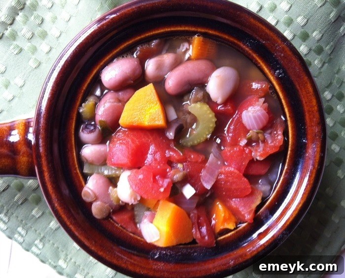 A comforting bowl of 15 bean soup, garnished with fresh herbs, ready to be enjoyed.