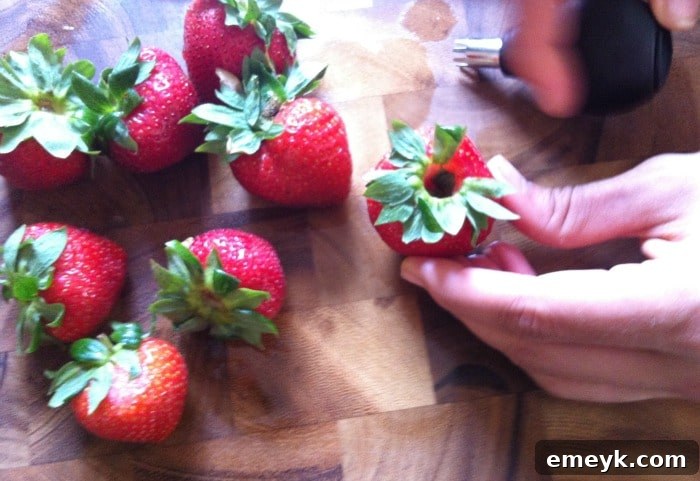 A basket full of ripe, red strawberries, ready for hulling.