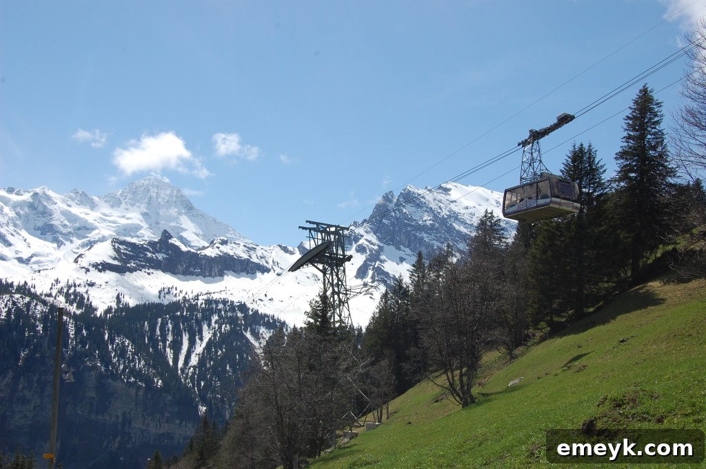Close-up view of a cable car cabin gliding through the Swiss Alps on the way to Schilthorn