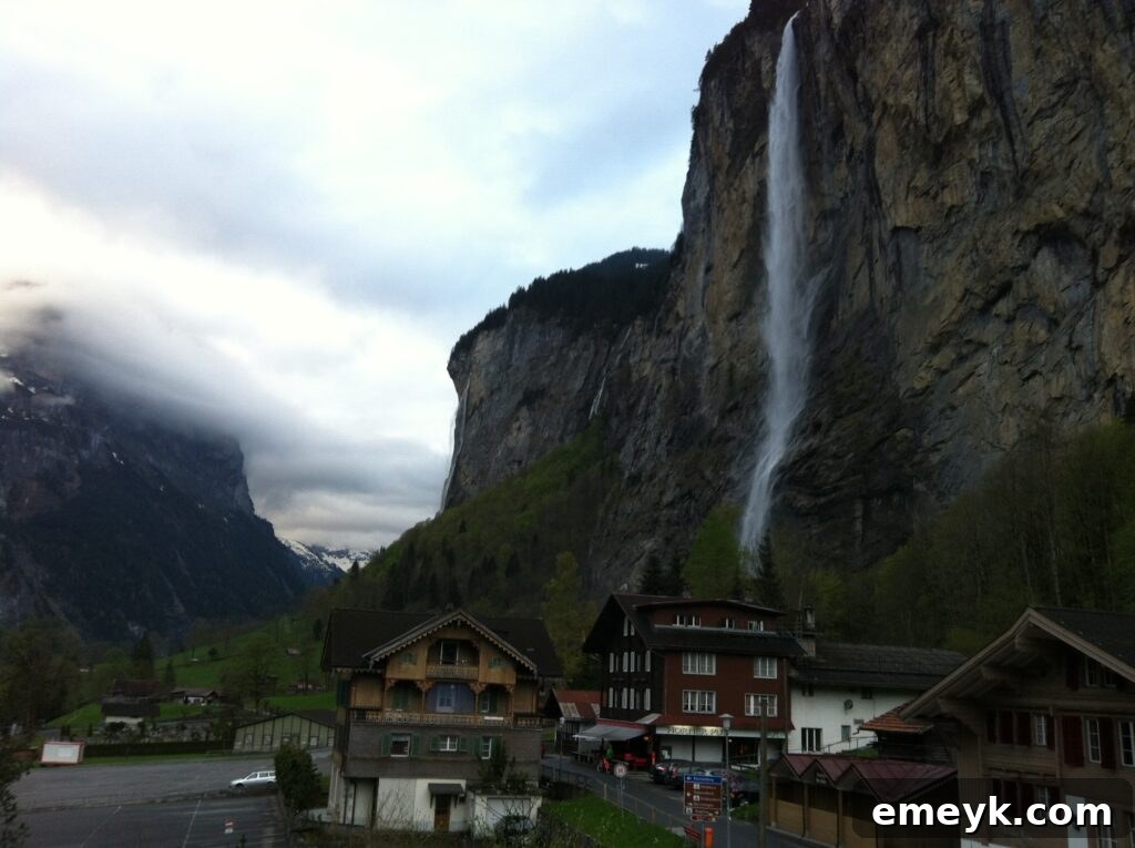 Scenic view of Lauterbrunnen Valley, Switzerland, with towering cliffs, lush greenery, and waterfalls