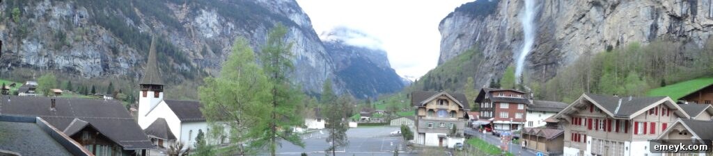 Panoramic view of the charming town of Interlaken with traditional buildings and green landscapes