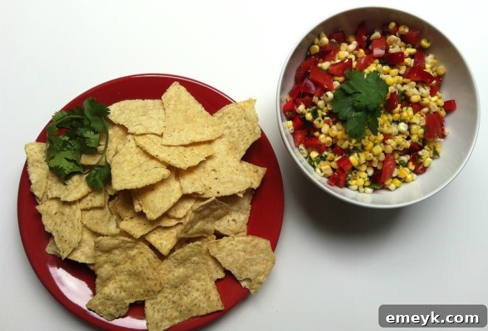 Tortilla chips ready to be dipped in Grilled Corn Salsa