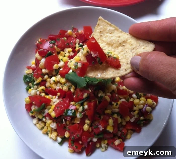 A tortilla chip loaded with delicious Grilled Corn Salsa