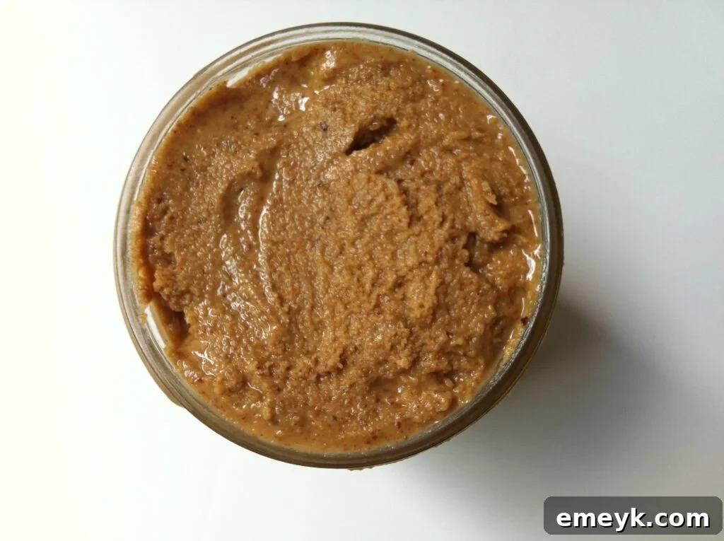 Freshly made jar of creamy almond butter, ready to be enjoyed