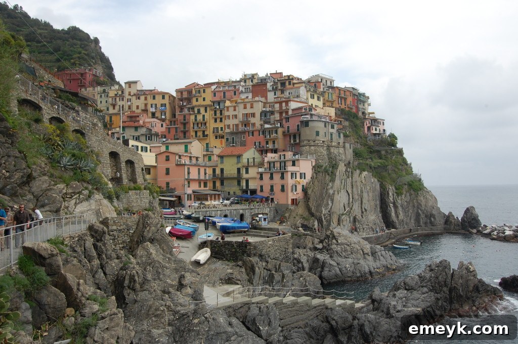 Stunning coastal view of Cinque Terre, Italy, showing rugged cliffs, terraced vineyards, and the blue Mediterranean Sea