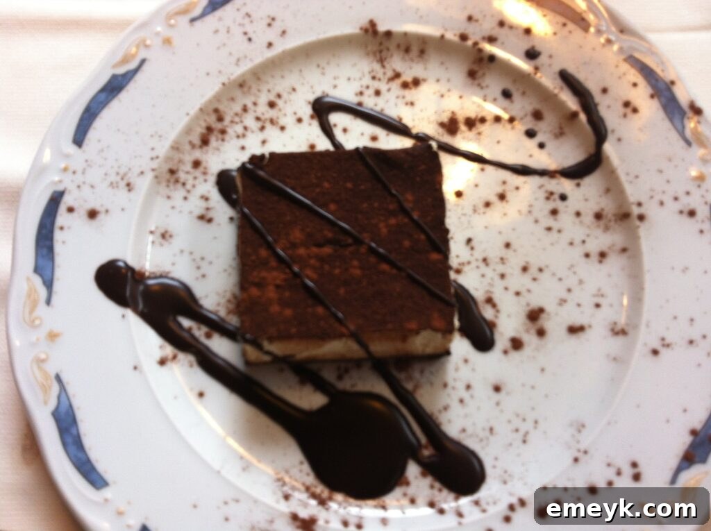 Decadent slice of tiramisu with cocoa powder dusting, a classic Italian dessert