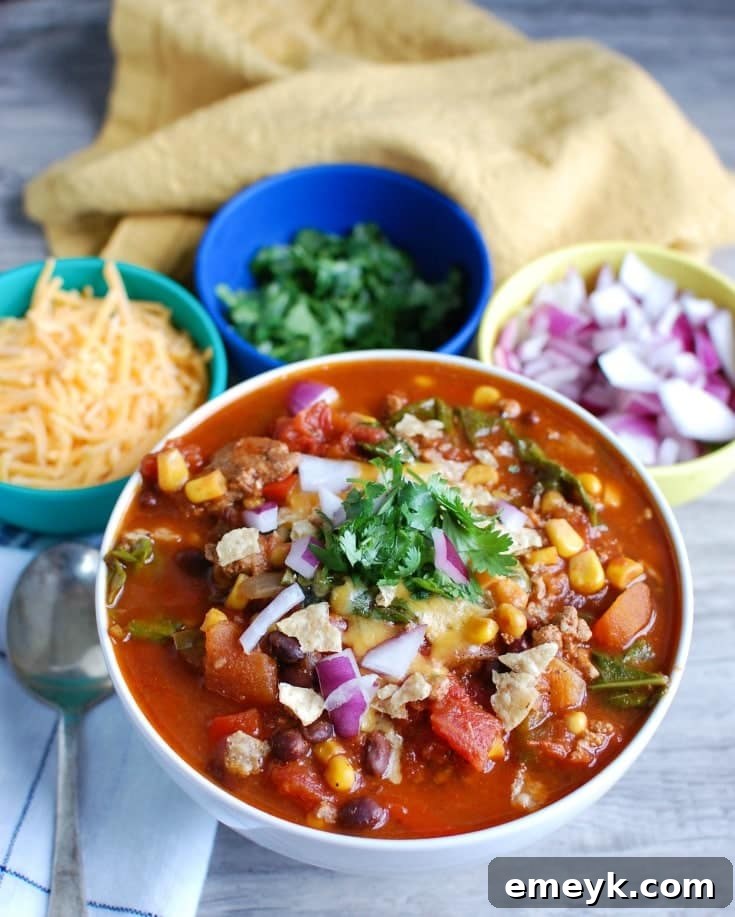 35 Stress Free Crockpot Meals for Back to School 11 Healthy Slow Cooker Turkey Kale Chili from A Cedar Spoon, a nutritious and comforting meal for busy evenings.