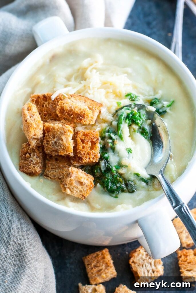 35 Stress Free Crockpot Meals for Back to School 18 Creamy Slow Cooker Potato Soup with Pesto from Peas and Crayons, a comforting and flavorful twist on a classic.