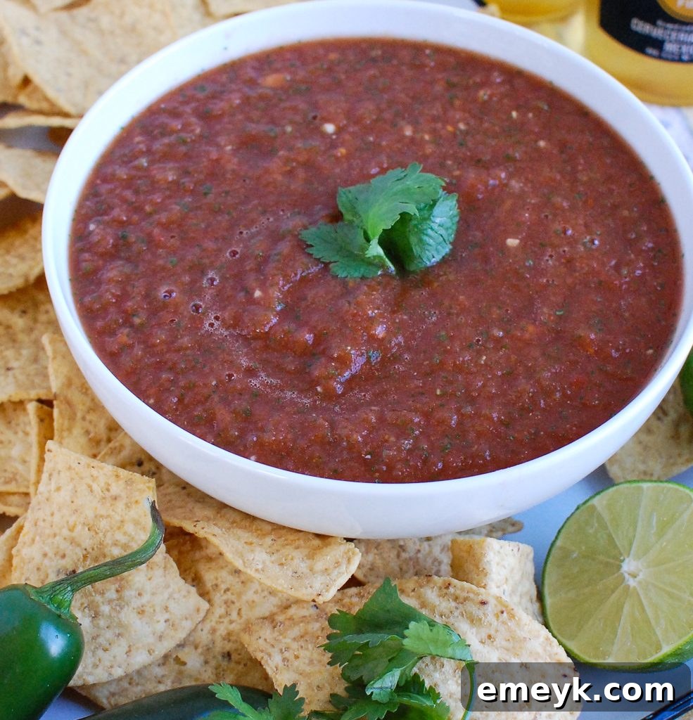 Homemade Salsa in a clear bowl with fresh cilantro garnish