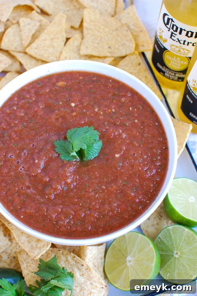 Homemade Salsa served with crispy tortilla chips in a white bowl, ready for dipping
