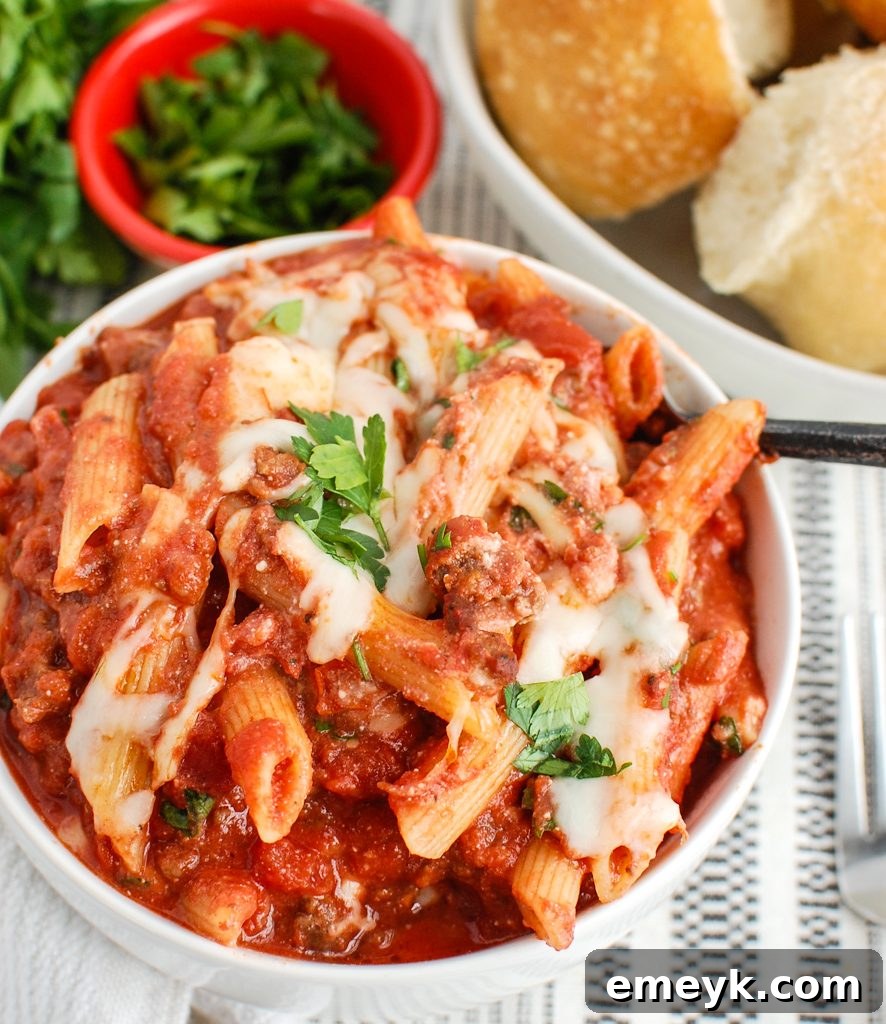 Baked Ziti with Ricotta being served with a fork, showing melted cheese and sauce