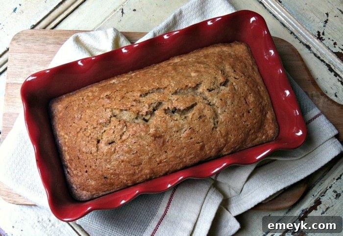 Delicious Zucchini Applesauce Bread slice with fall colors in the background