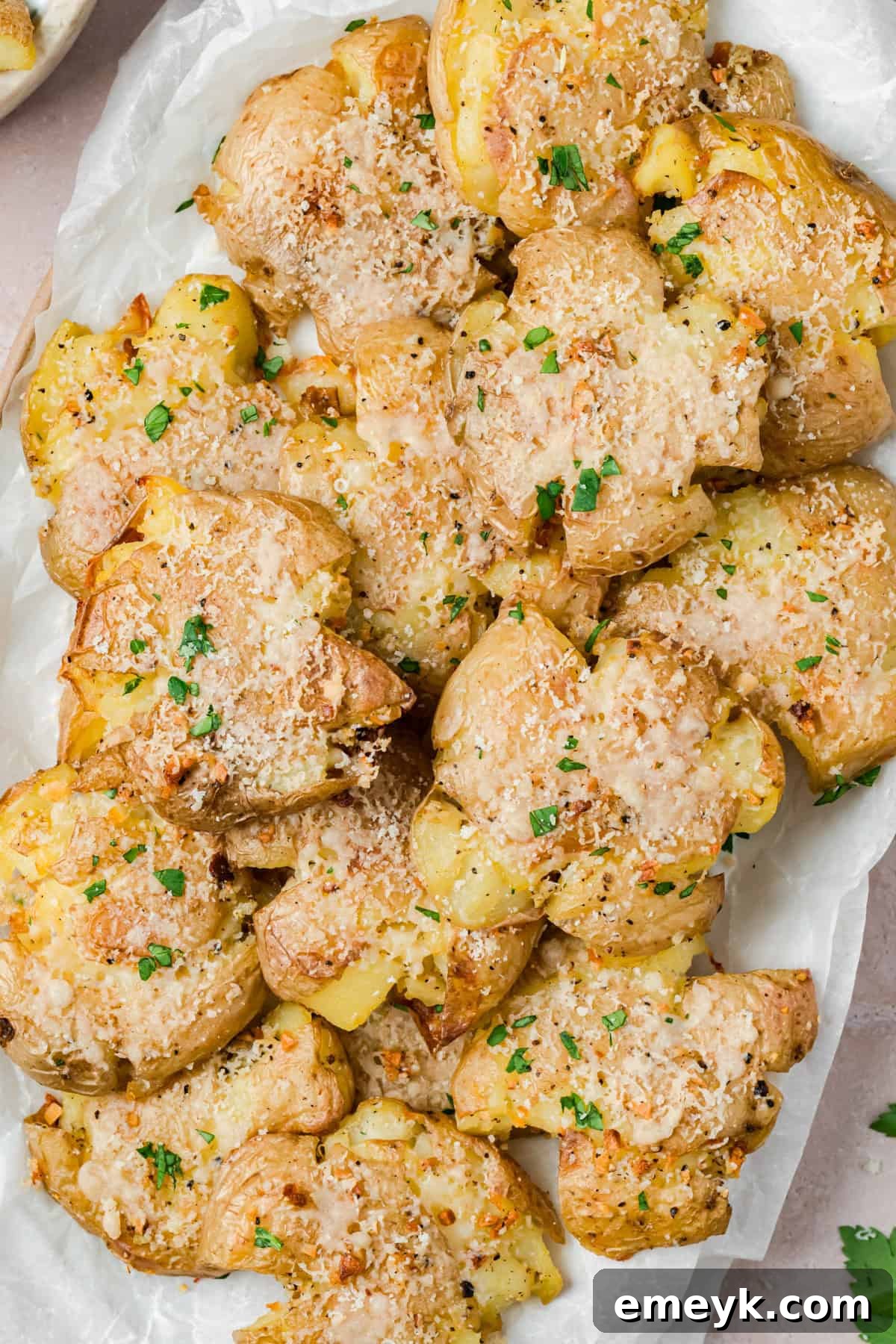 Garlic Parmesan Smashed Potatoes on a white plate