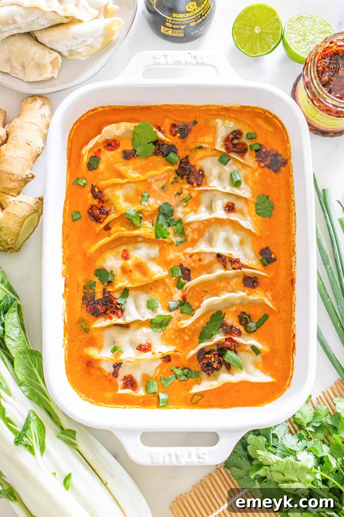 One-pan dumpling casserole covered with foil, ready for baking.