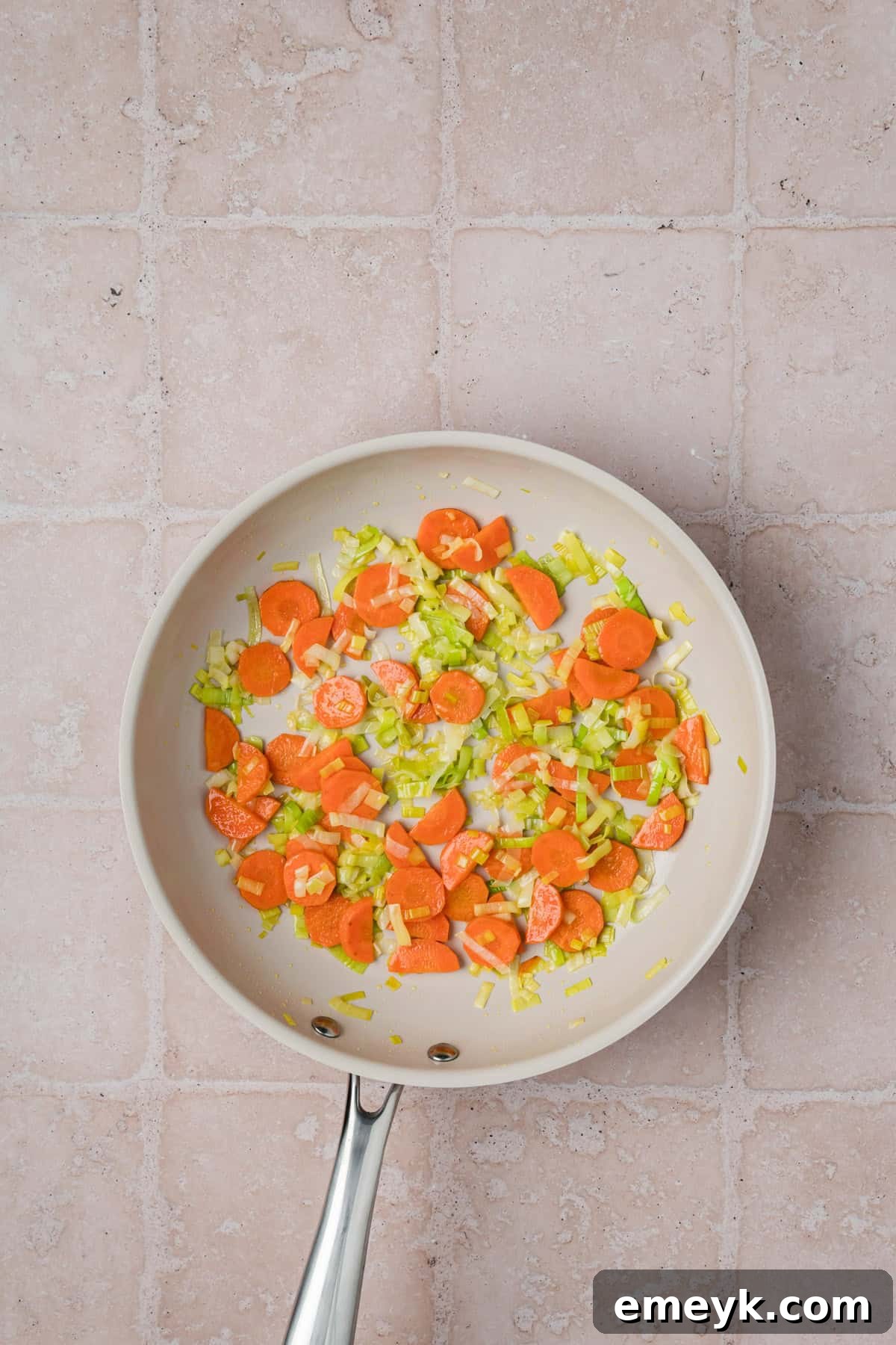 Simple French Lentil Salad Recipe, showing carrots sautéing in a pan
