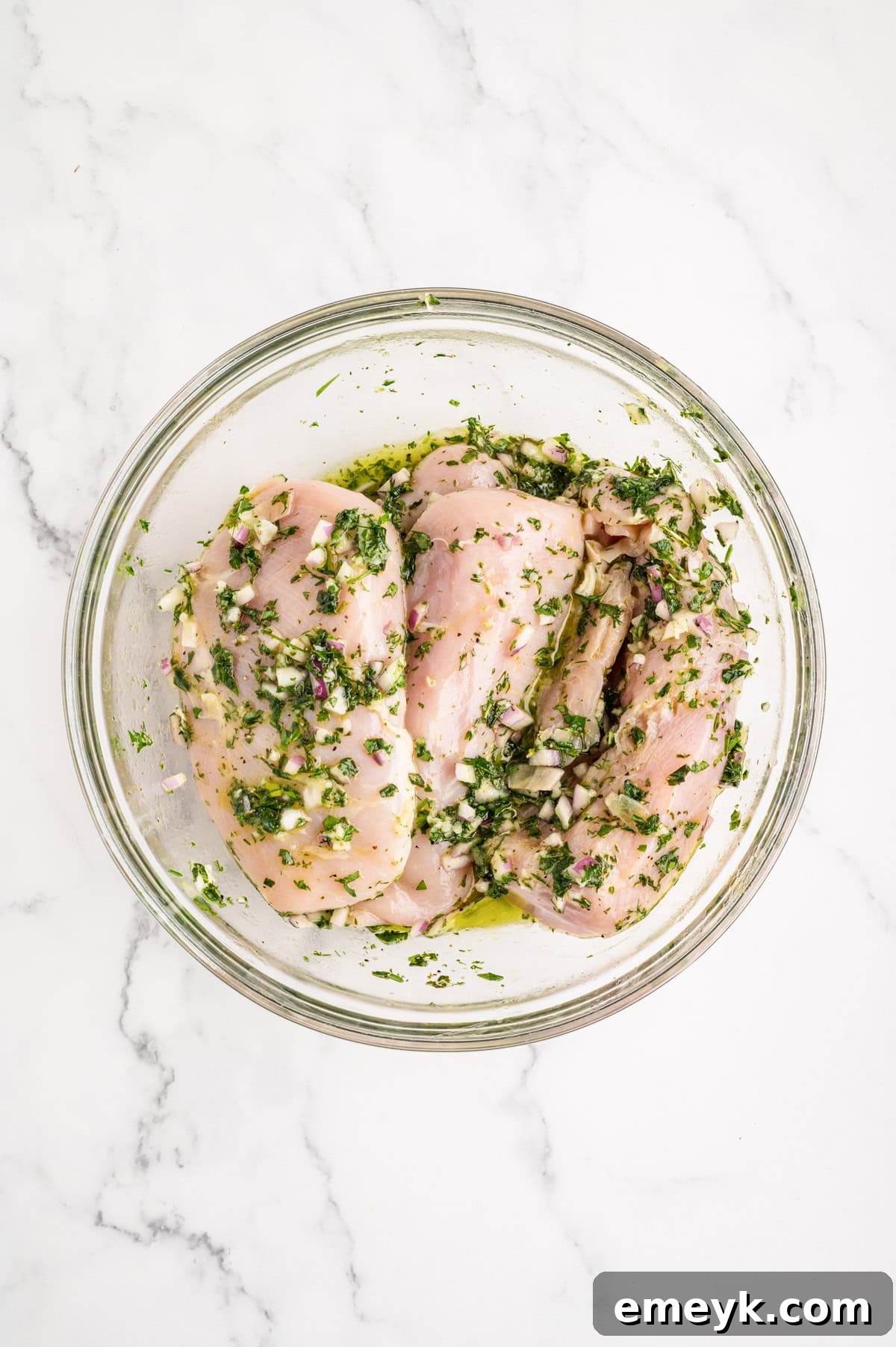 Chicken marinating in glass bowl 