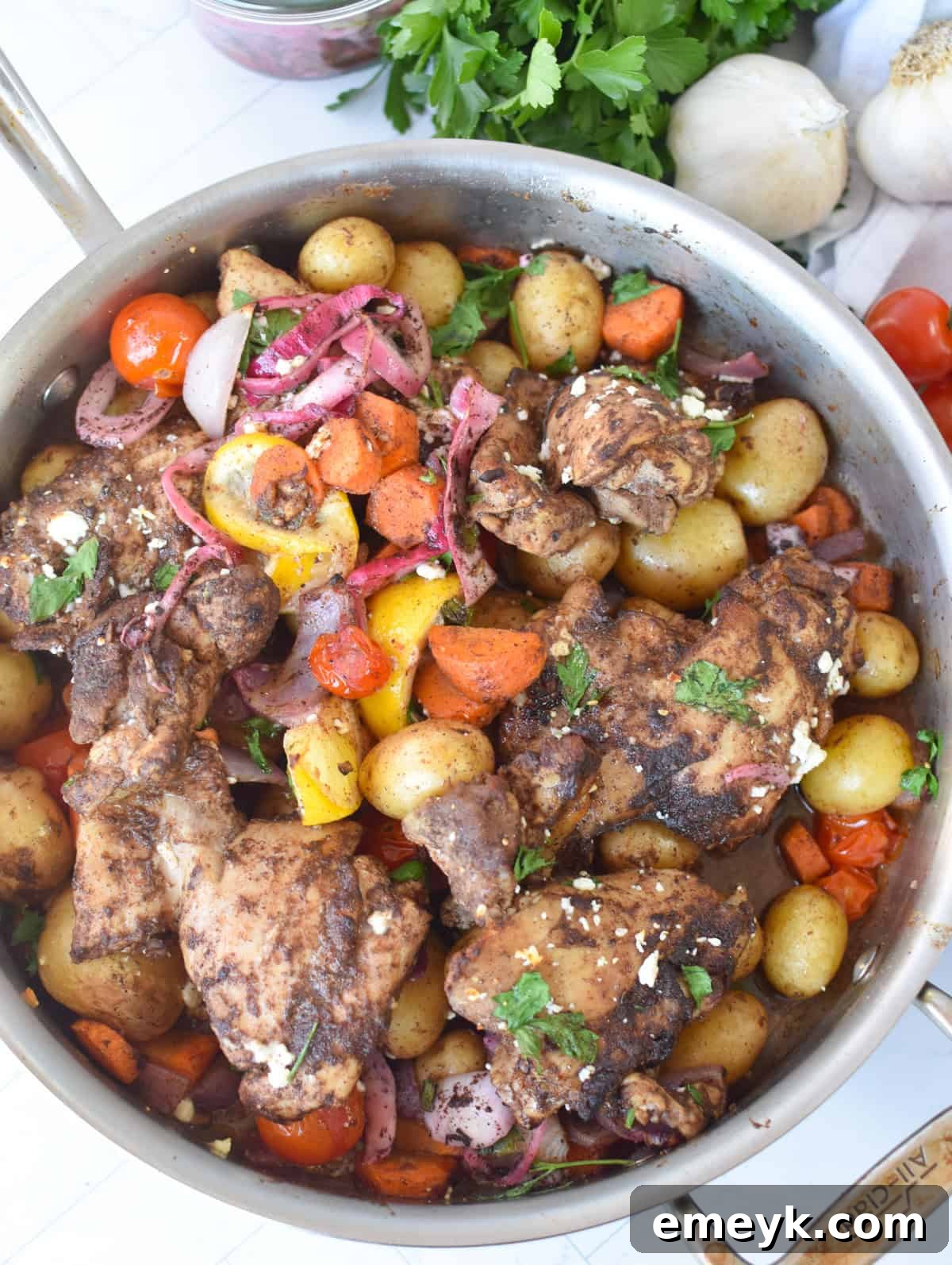 One pan Lebanese 7 spice chicken thighs with potatoes carrots and cherry tomatoes