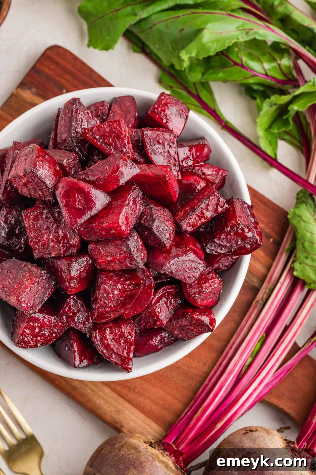 Quick and Easy Foil Free Roasted Beets 2 A white serving bowl filled with perfectly oven-roasted balsamic beets, ready to serve.