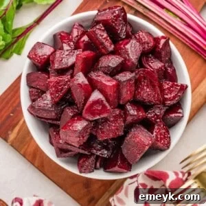 Quick and Easy Foil Free Roasted Beets 10 Simple Oven Roasted Beets in a white bowl with a spoon.