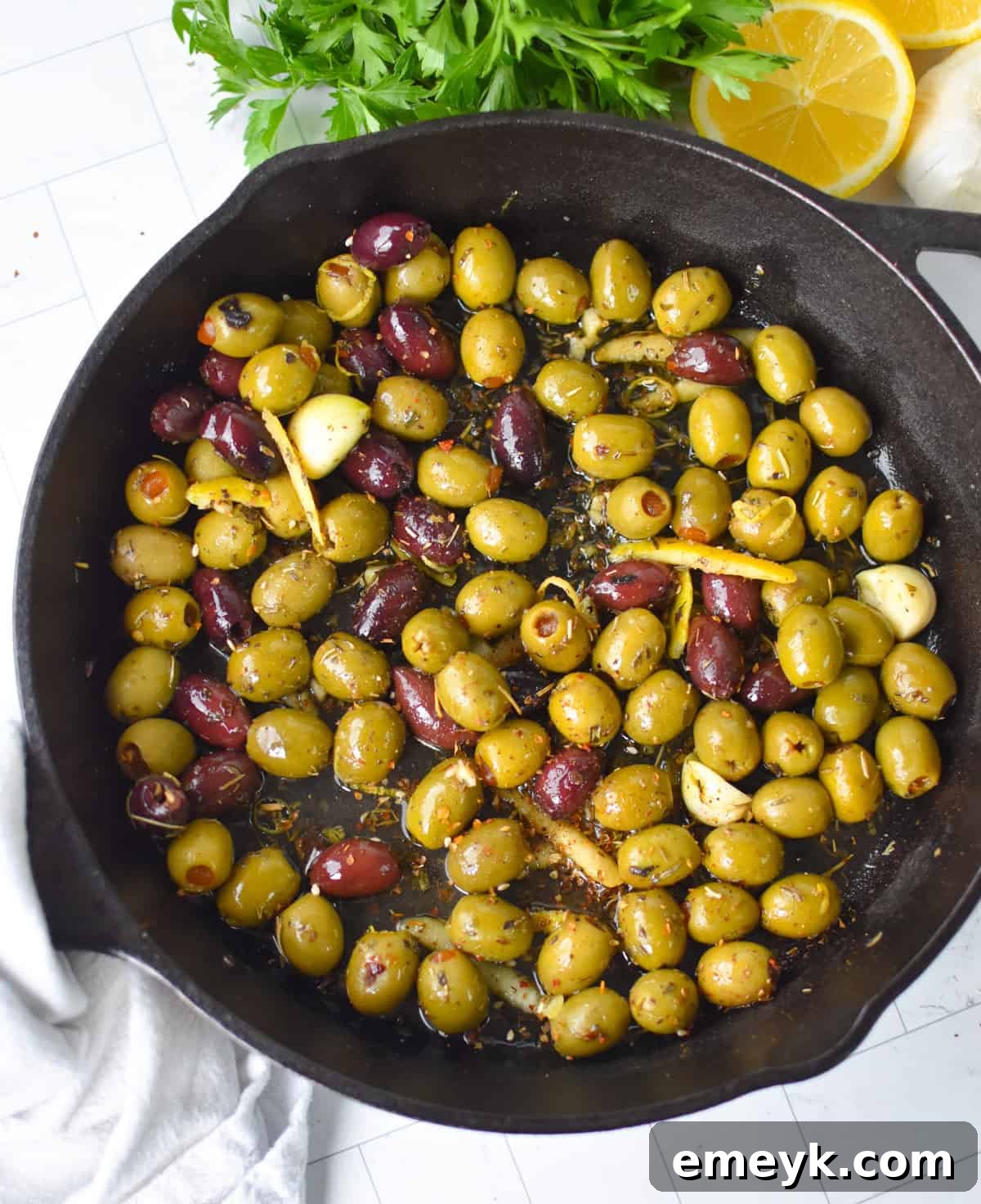 Warm Olives with Mediterranean Herbs in a Cast Iron Skillet 