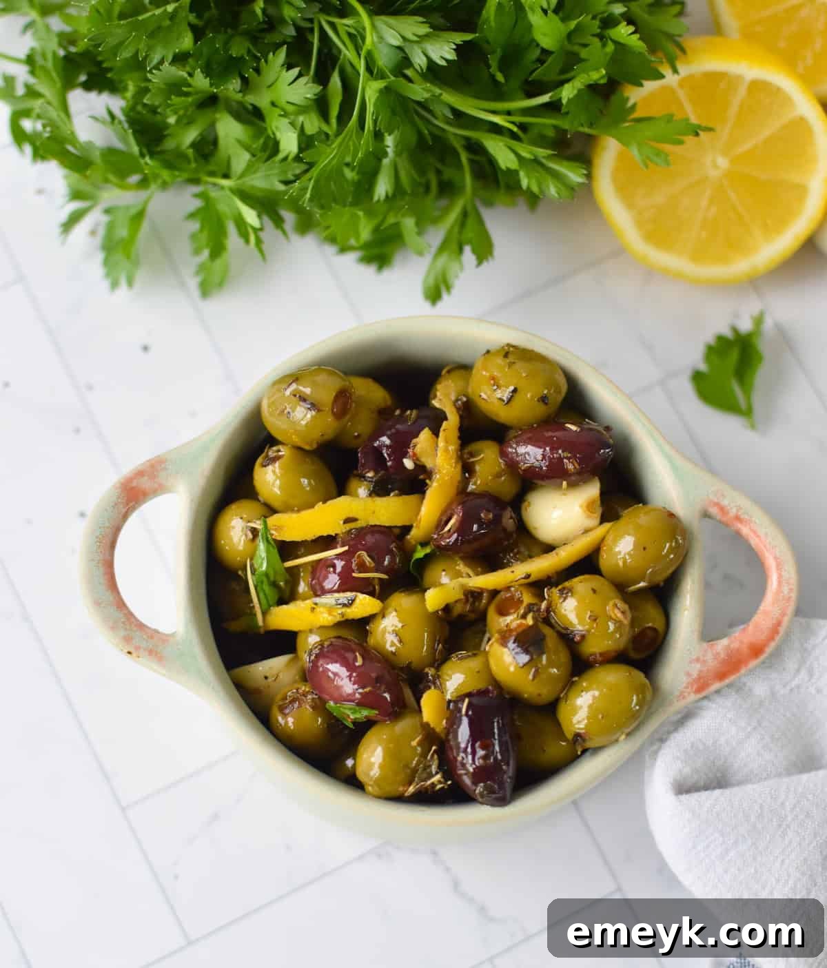 Bowl of warm Mediterranean olives with fresh parsley garnish