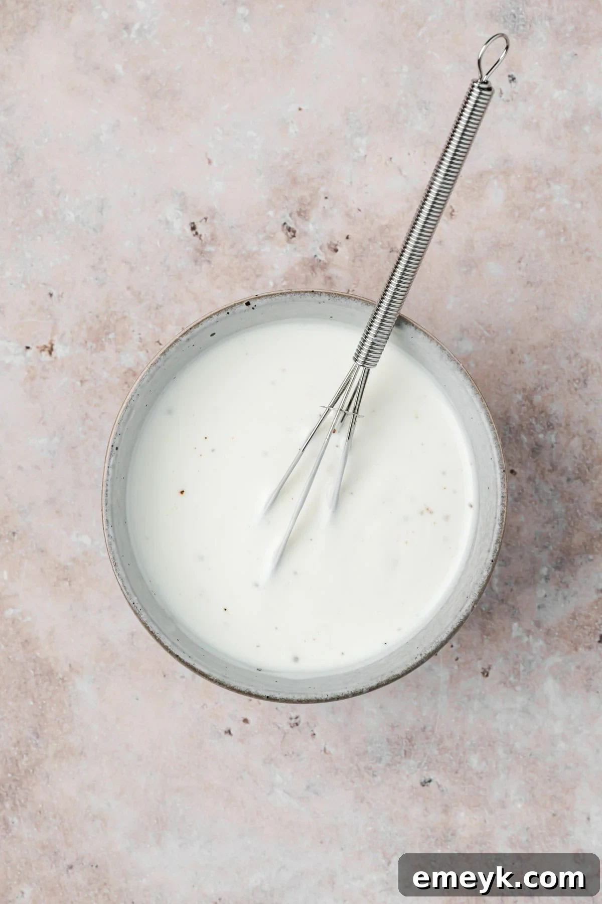 Garlic Yogurt Sauce in bowl with whisk