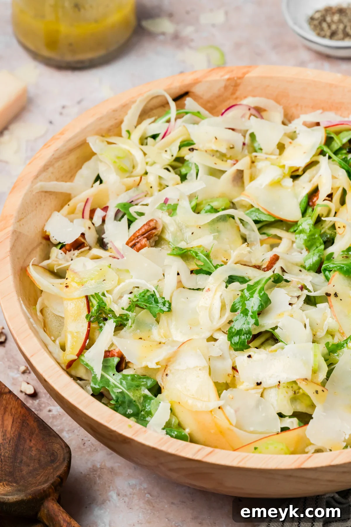 Overhead view of apple fennel salad with arugula, pecans, and Parmesan