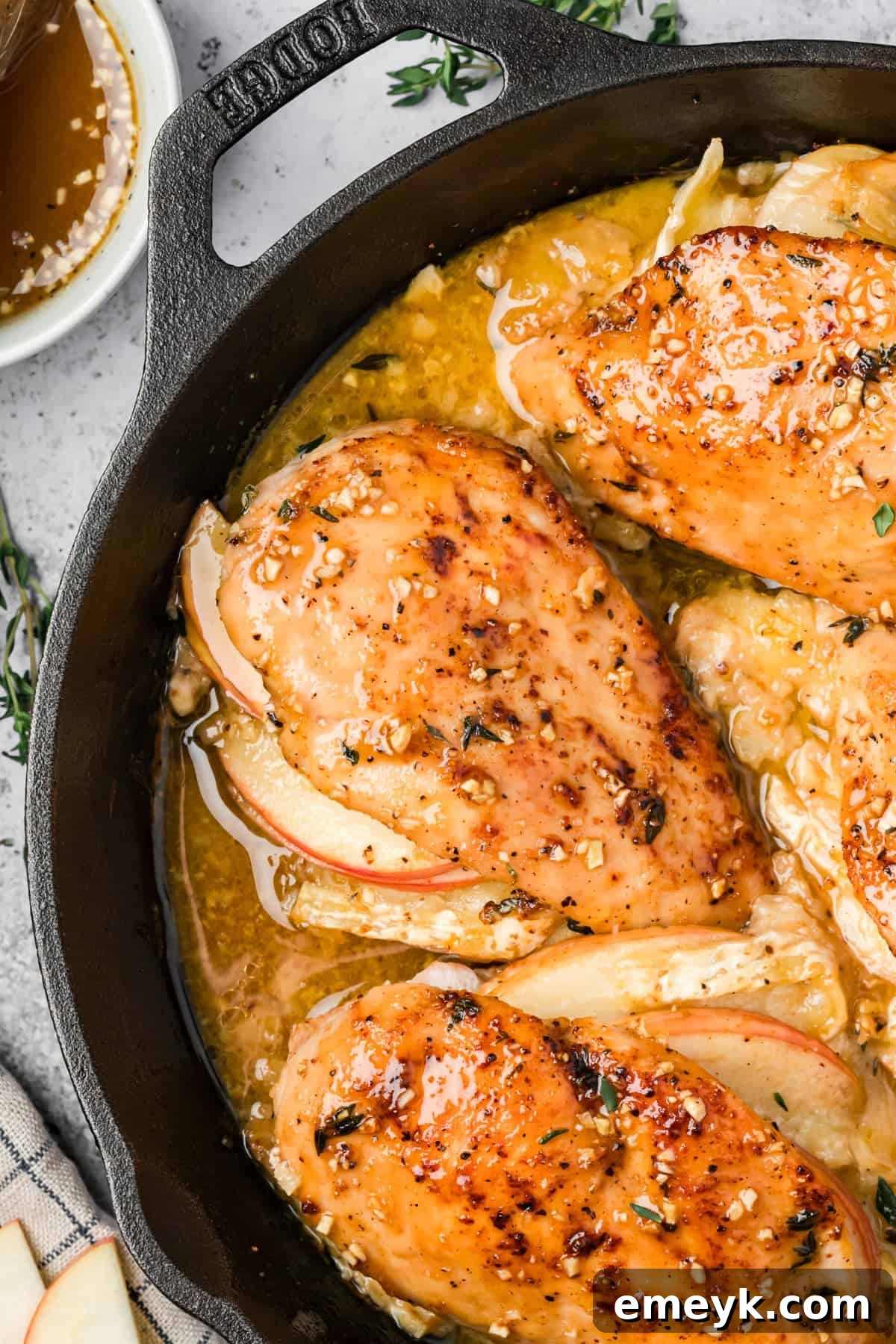 Apple and brie stuffed chicken cut open showing melted cheese and apple filling