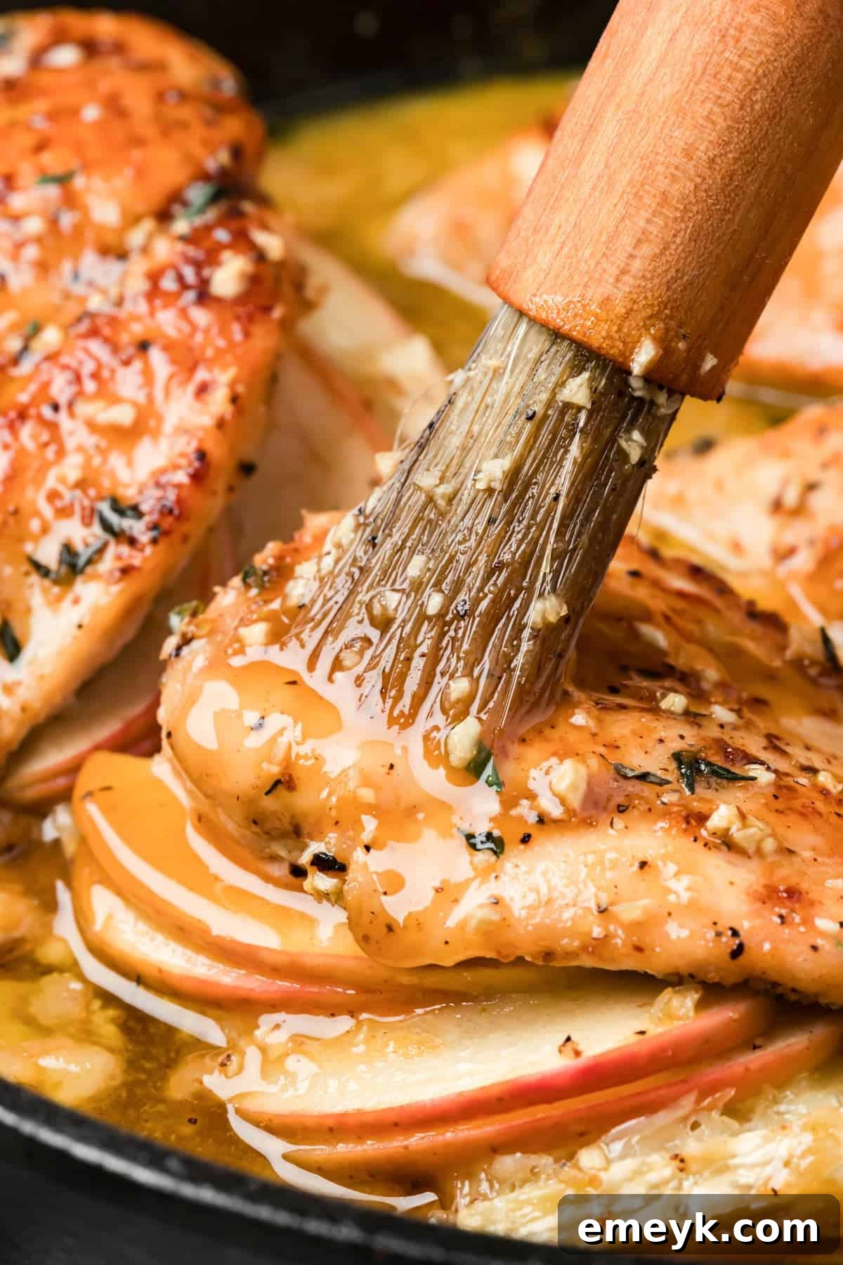 Brushing chicken with maple glaze
